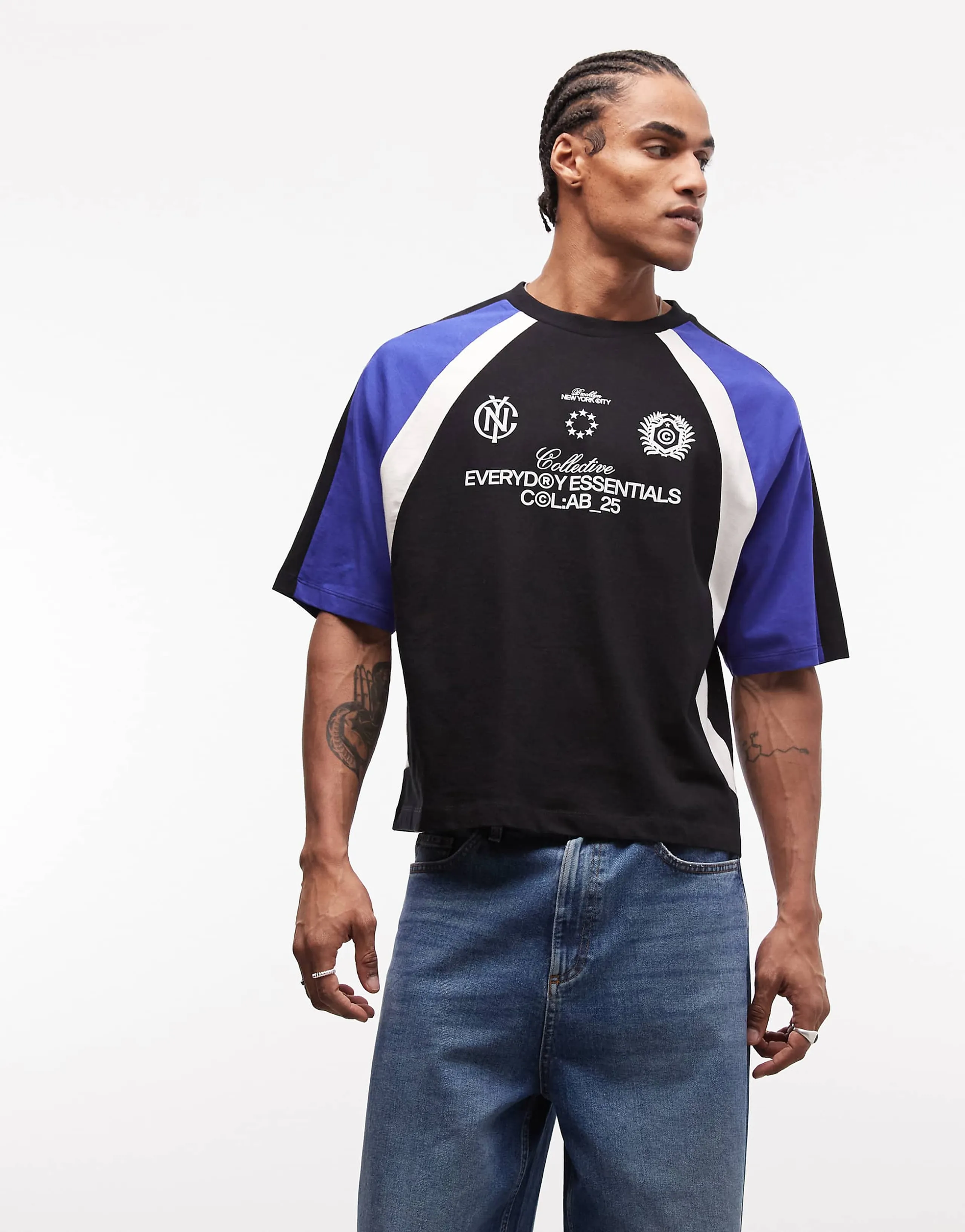 ASOS DESIGN boxy oversized t-shirt with cut and sew paneling and soccer graphics in black