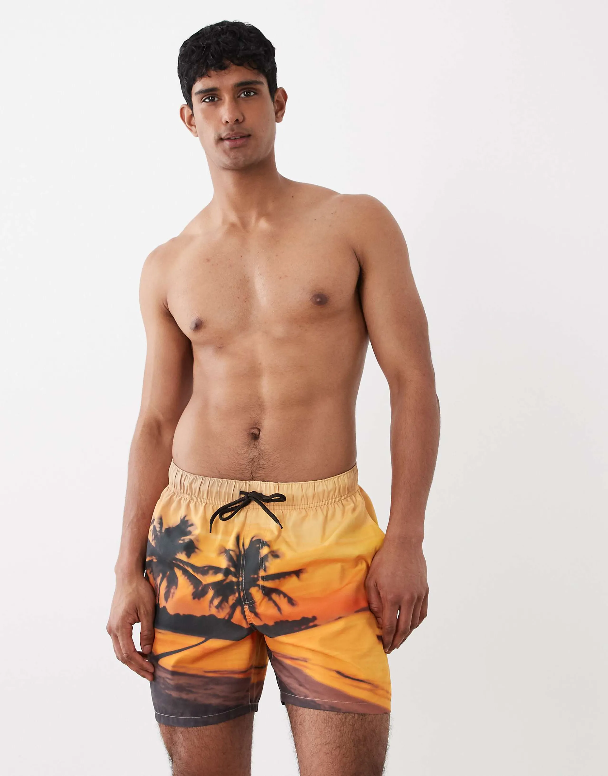 ASOS DESIGN swim shorts in mid length with beach sunset print in orange