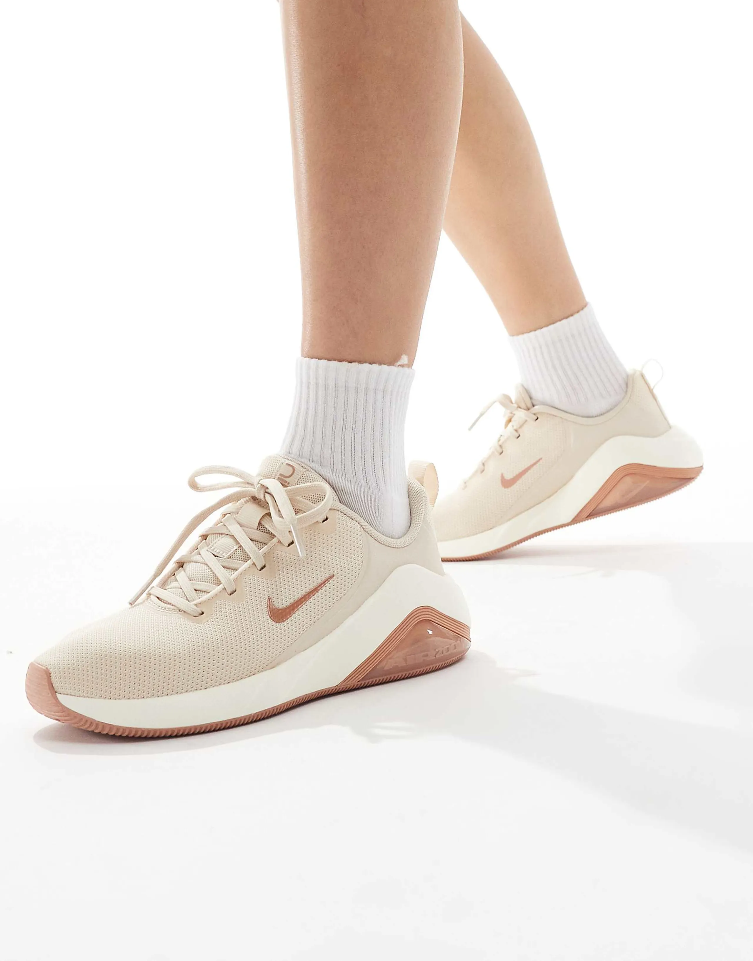 Nike Bella 7 sneakers in rose gold
