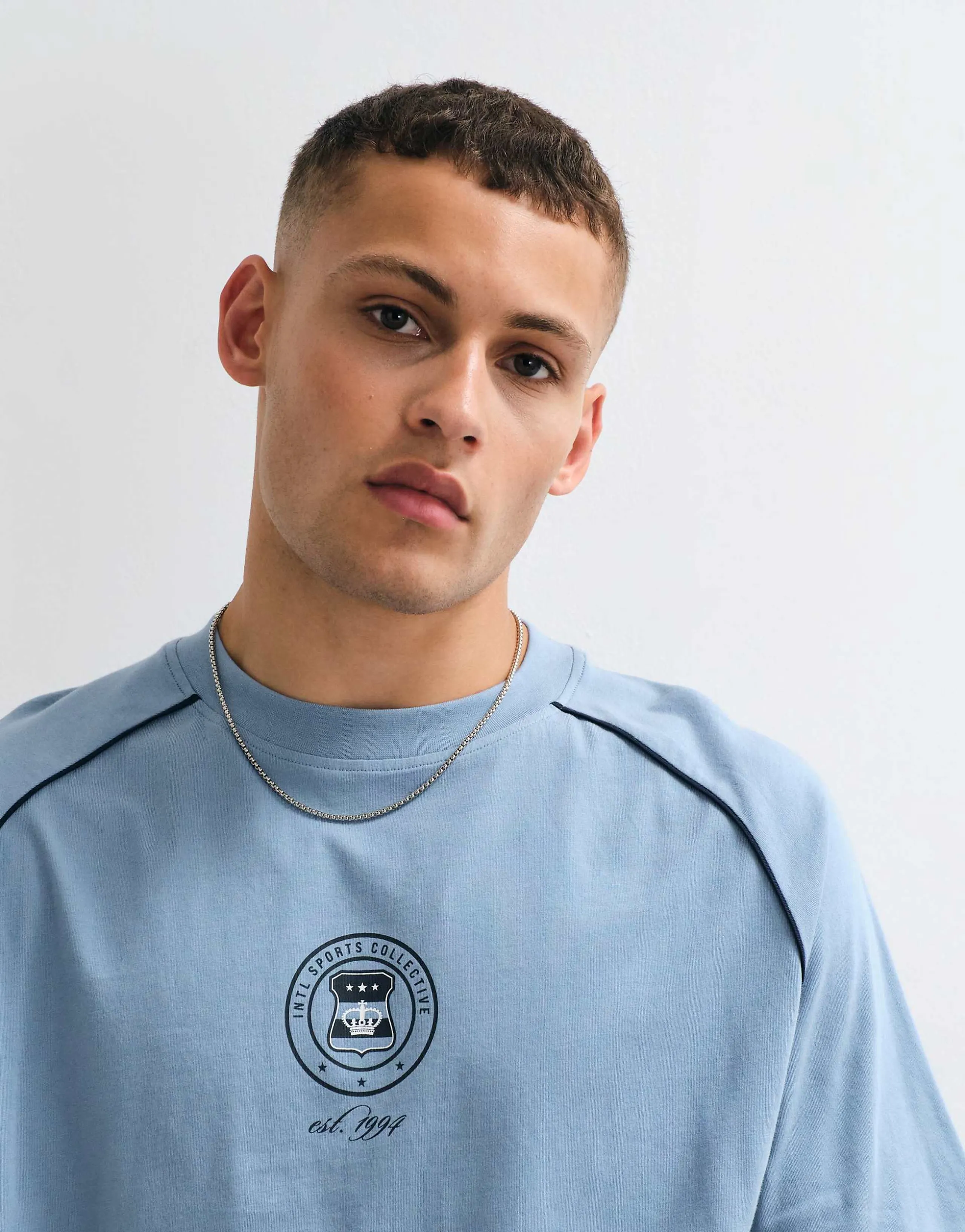 ASOS DESIGN boxy oversized cut and sew T-shirt with sports graphic in blue