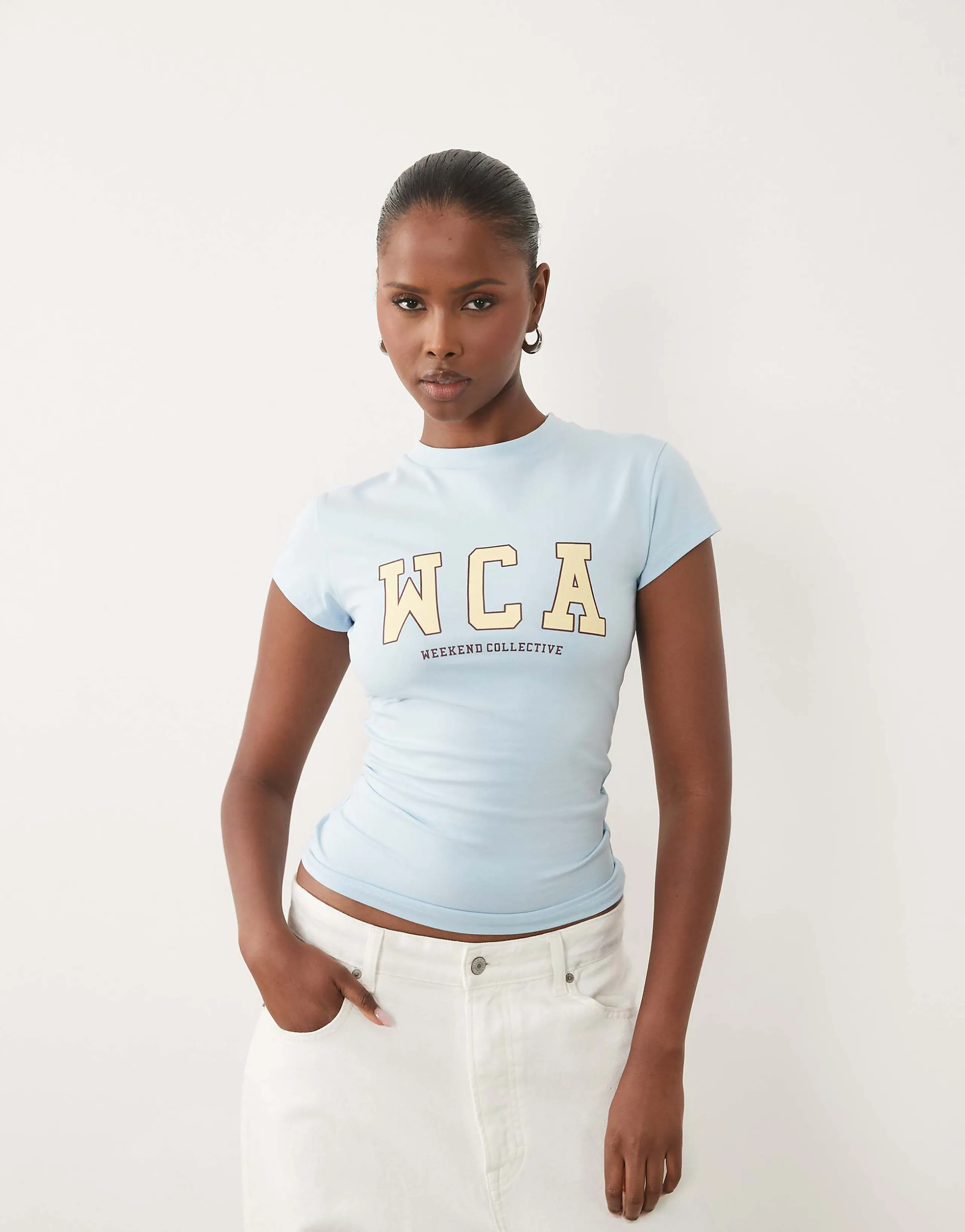Weekend Collective Icon baby tee with WCA graphic in baby blue