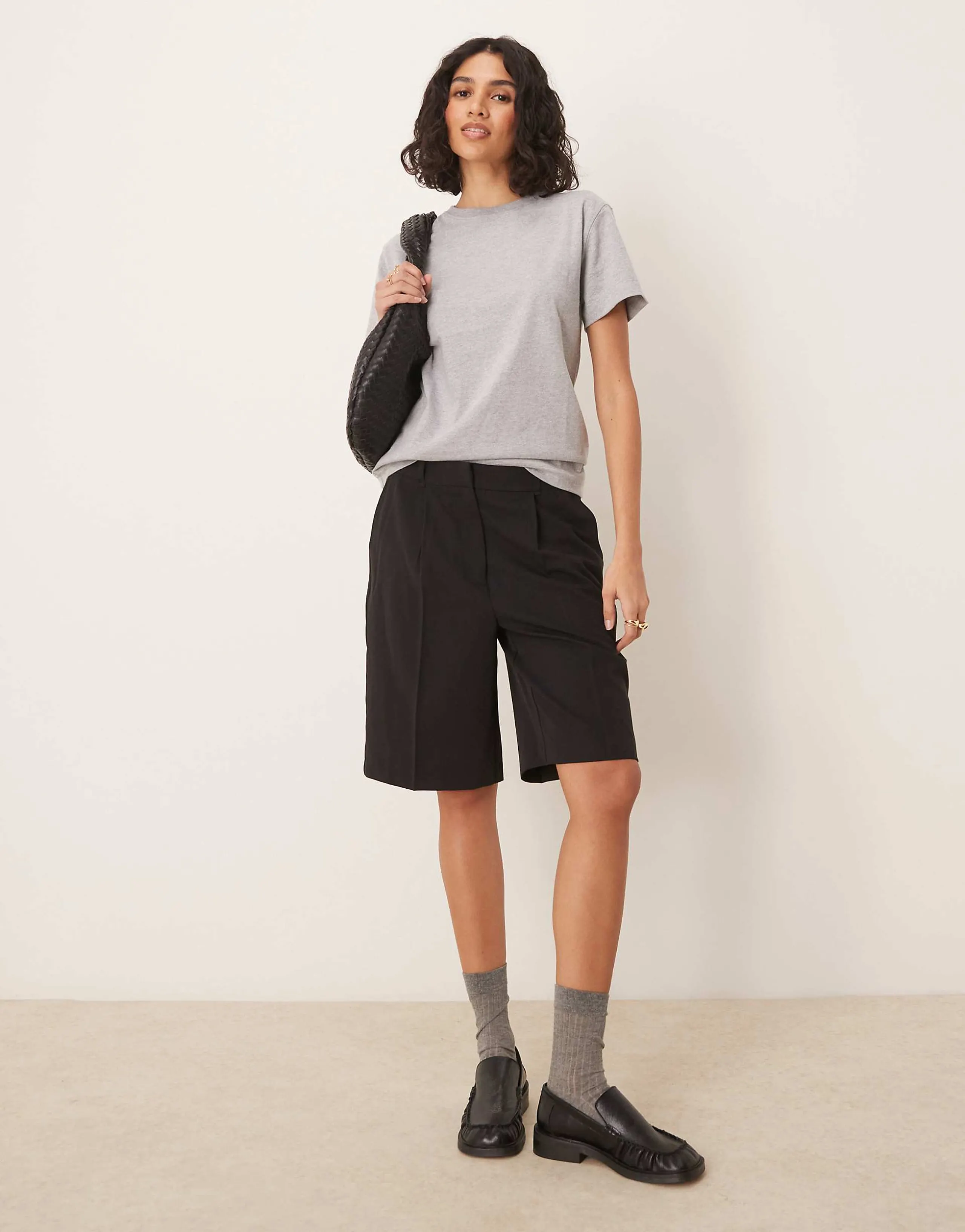 AWARE pleat front tailored shorts in black