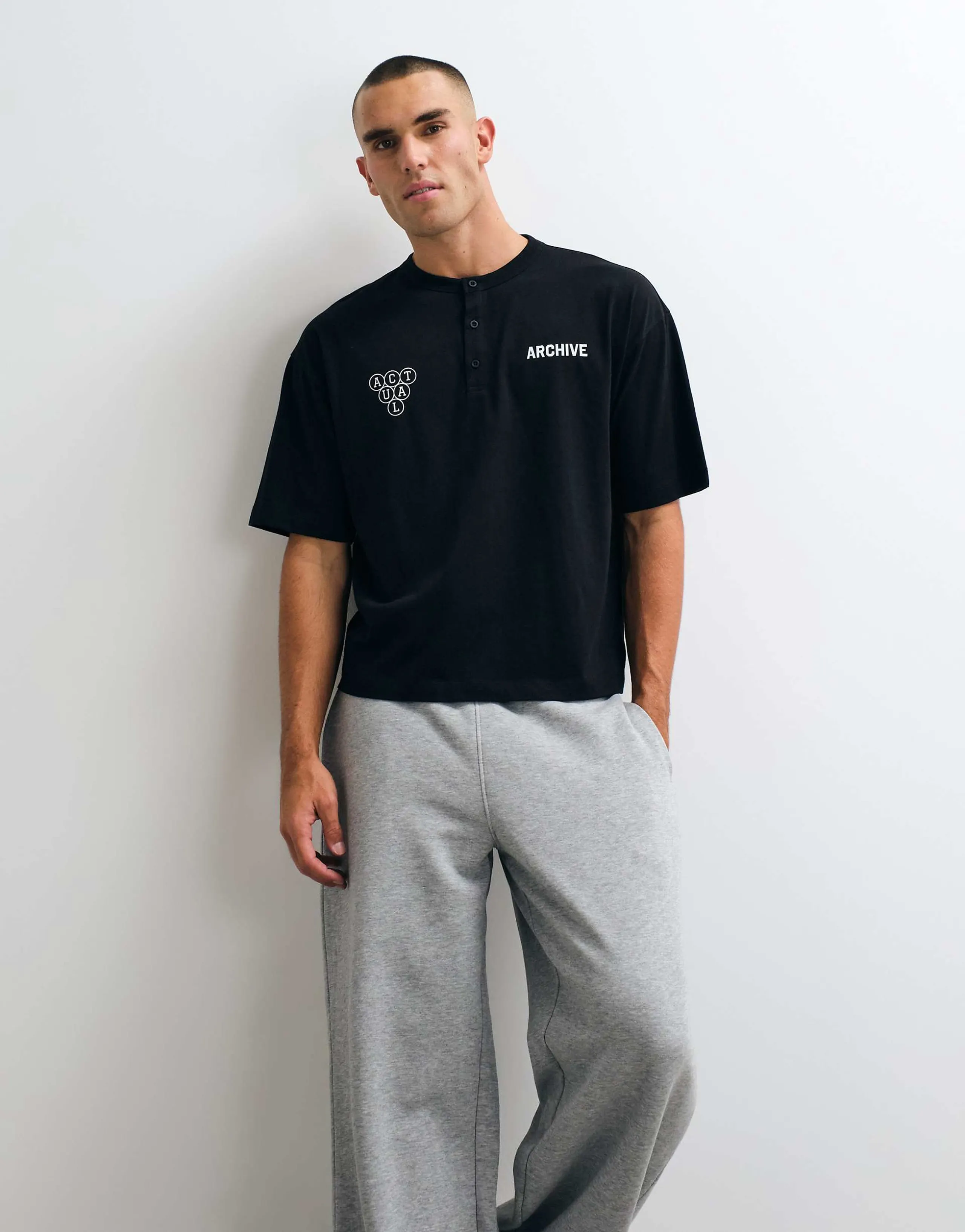 ASOS DESIGN boxy oversized henley t-shirt with text graphic in black